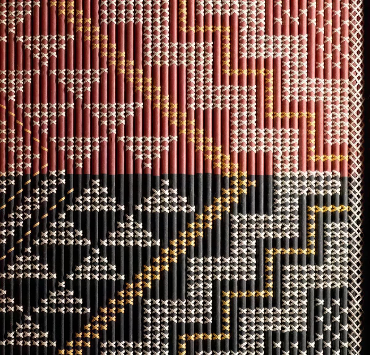 A tukutuku panel in red, black and white