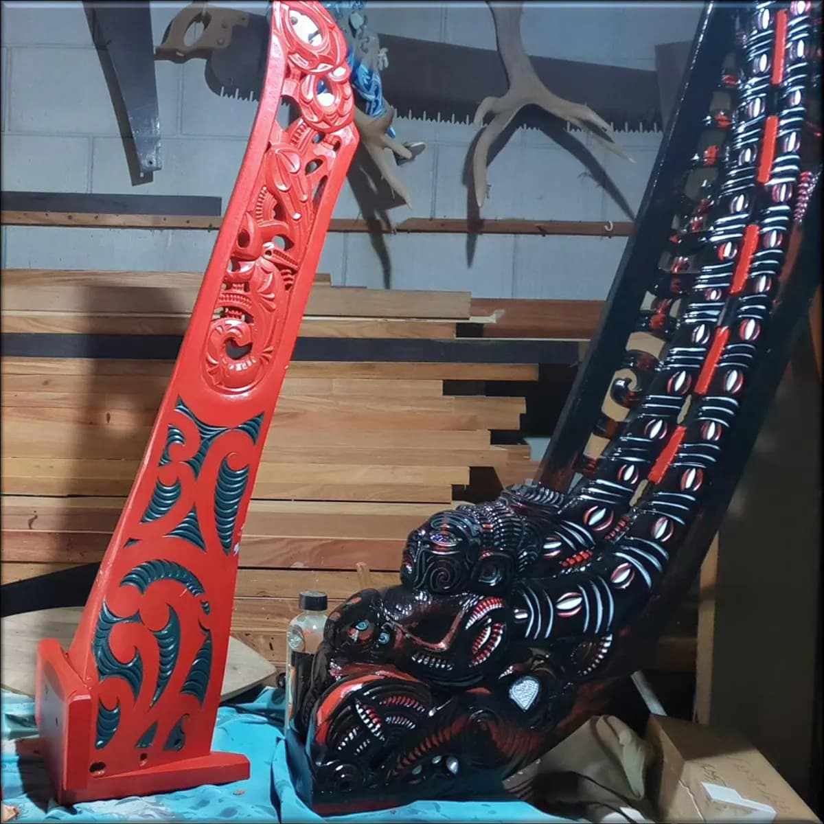 Carved and painted timber pieces in a carver’s workshop