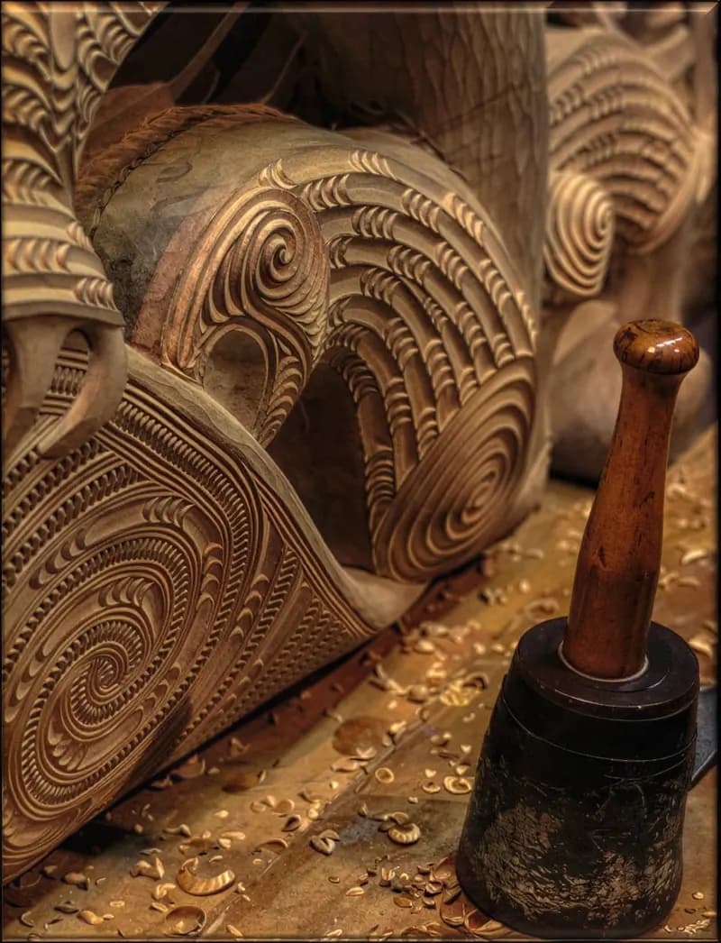 Carving tools resting on a carved timber piece